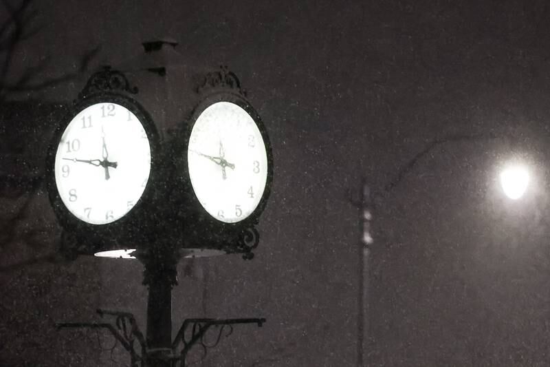 Heavy snow begins to fall near the clock along West Jefferson Street late Tuesday night. Tuesday, Feb. 1, 2022 in Joliet.