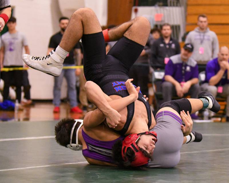 Zach Stewart of Marmion Academy flips over Caden Chiarelli of Downers Grove North during the 138 weight class regional title match where Zach took the win on Saturday Feb. 3, 2024 held at Glenbard West High School.