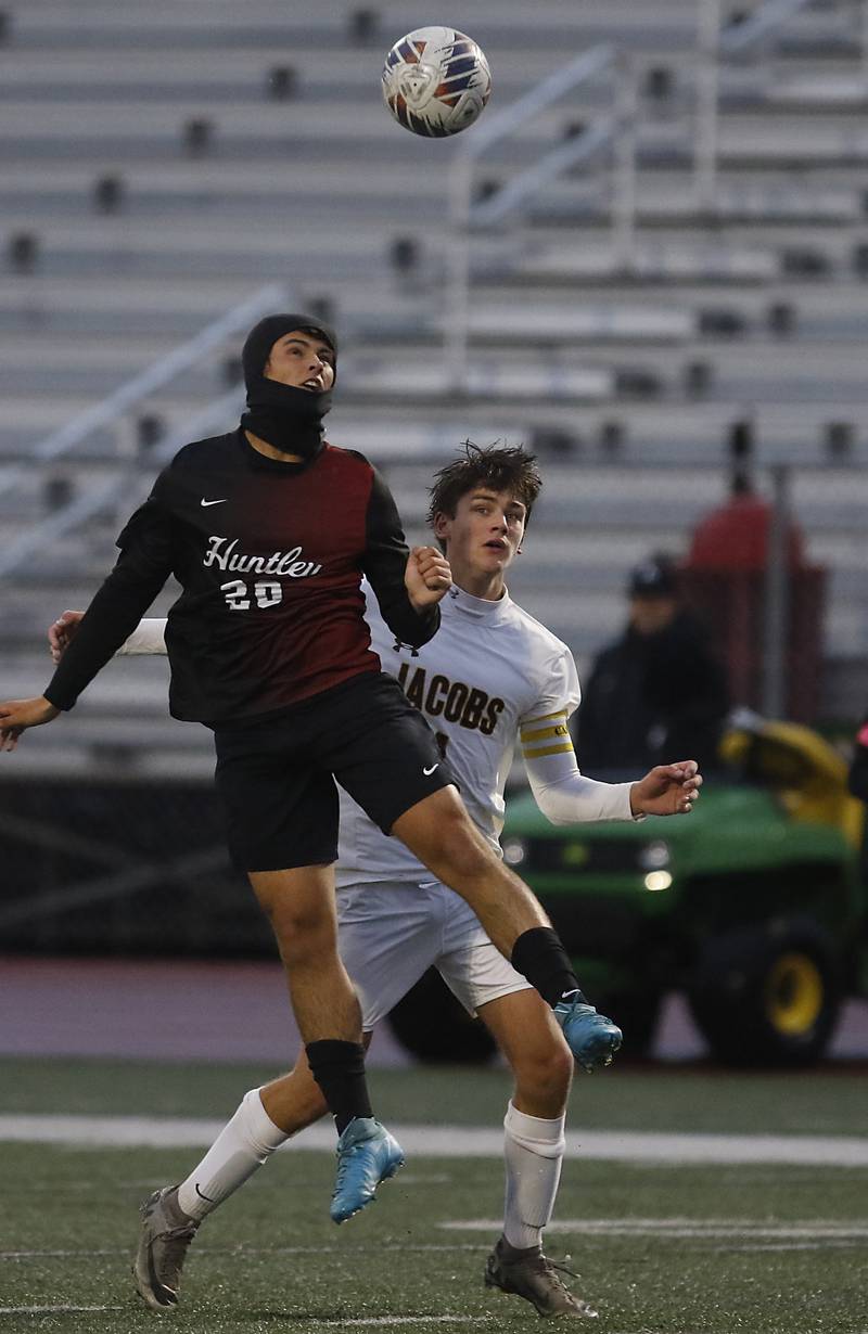 Huntley's Joe Lengle heads the ball as he is defended by Jacobs' Andrew Deegan during an IHSA Class 3A Huntley Regional boys soccer semifinal match on Tuesday, Oct. 21, 2025, at Huntley High School.