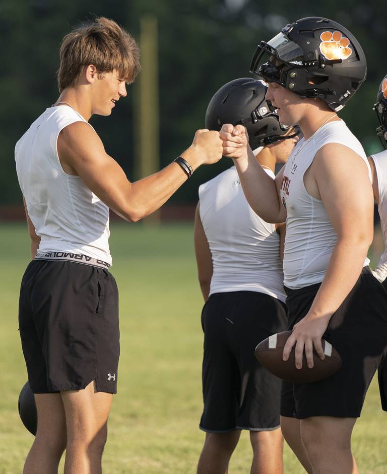 Crystal Lake Central wide receiver George Dimopoulos, left, and Tommy McNeil fist bump during a 7 on 7 football practice held on Thursday, July 21, 2022 at Crystal Lake Central High School. Ryan Rayburn for Shaw Local