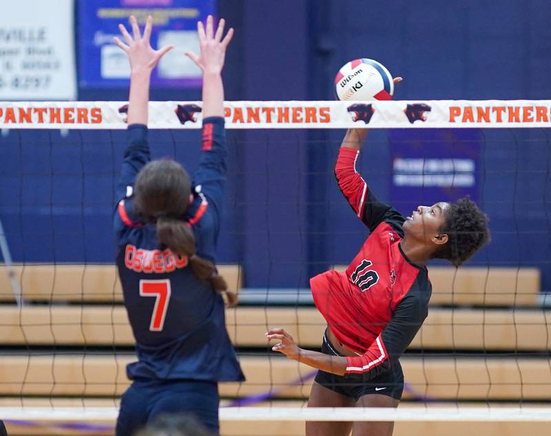 Yorkville's Joelle Pye-Blacknard (10) goes up for a kill against Oswego’s Kelsey Foster (7) during a volleyball match at Oswego High School on Thursday, Sept. 14, 2023.