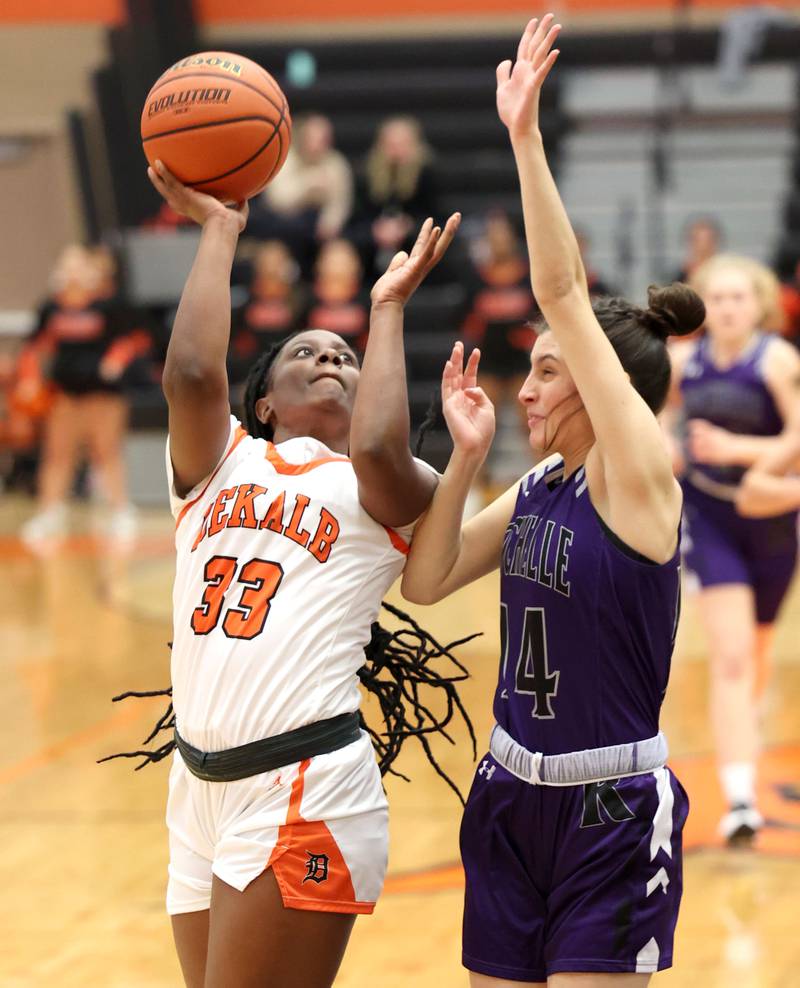 DeKalb's Cayla Evans gets an and one after being fouled by Rochelle's Megan Seebach during their game Monday, Nov. 28, 2022, at DeKalb High School.