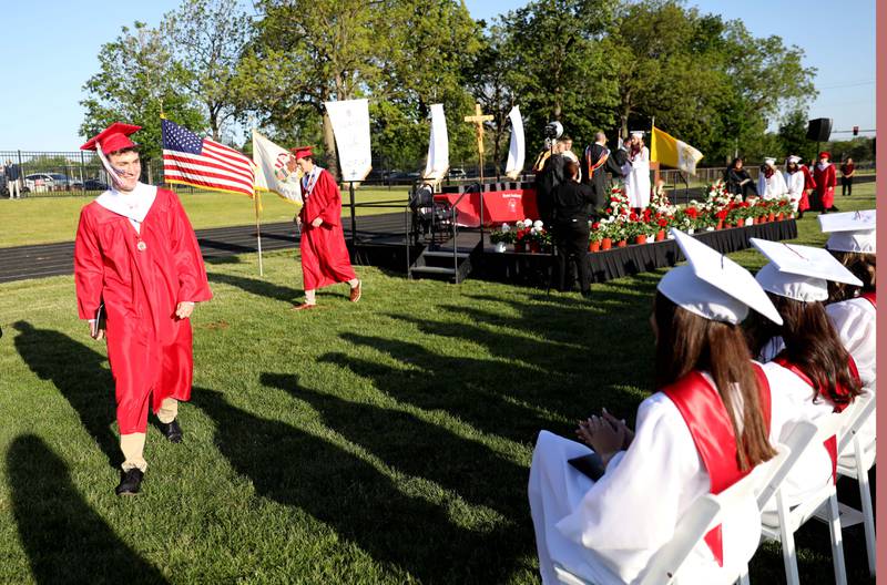 Benet graduates return to their seats after receiving their diplomas during the school’s commencement ceremony in Lisle on Thursday, May 25, 2023.