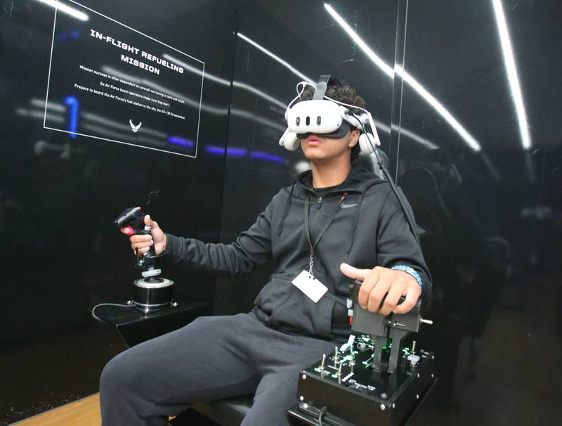 Marquis Lorenzi, a student at La Salle-Peru Township High School, pilots an F-35 fighter through a canyon during “Own The Sky,” a USAF Virtual Airborne Experience on Wednesday, March 19, 2025 in the Dolan Building parking lot at L-P High School. Students had the option to pilot an F-35 fighter through a canyon using a real-life throttle and flight stick or operate a replica KC-135 boom pod to refuel several airborne aircraft including a B-2 Stealth Bomber. The simulator was brought to La Salle-Peru Township High School with the help of the U.S. Air Force recruitment office inside the Peru Mall.