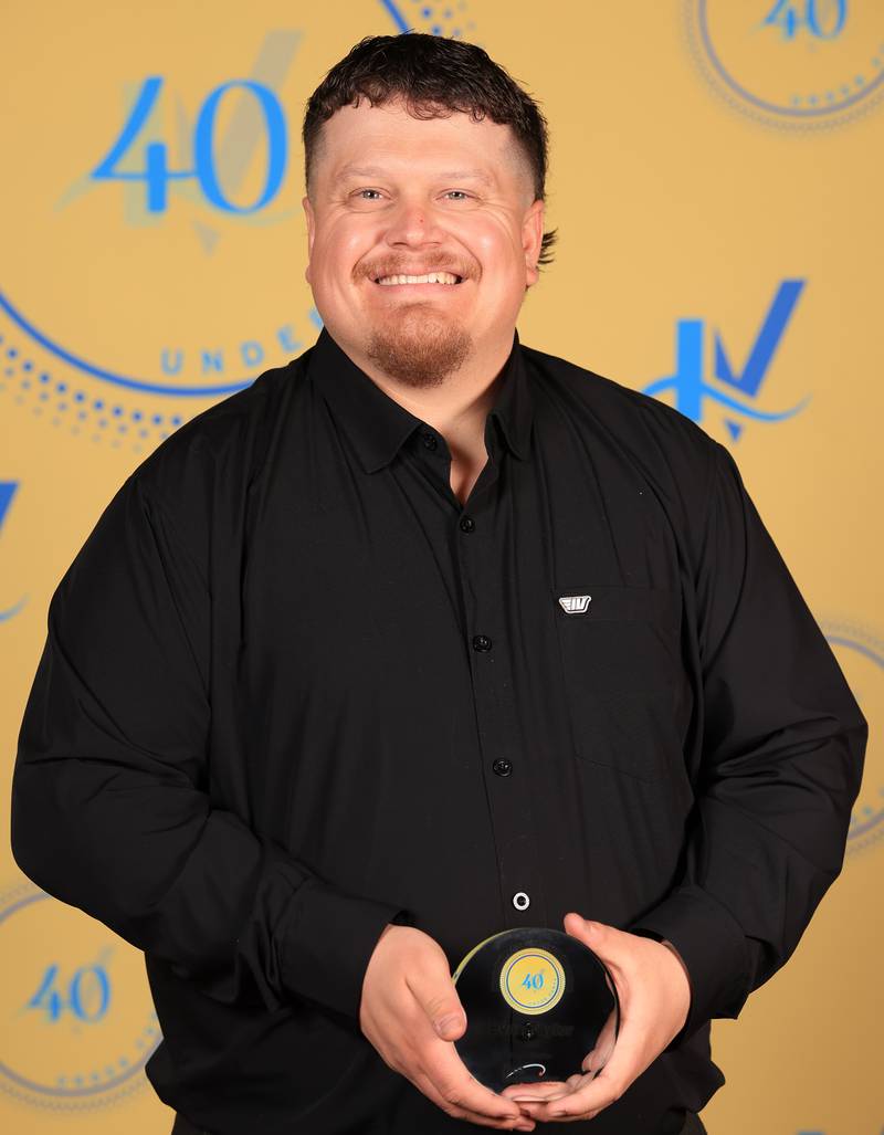Evan Taylor poses with his 40 Under Forty award during the Illinois Valley Chamber of Commerce Champions of Change Awards Night on Thursday, April 10, 2025 at the Westclox Event Center in Peru.