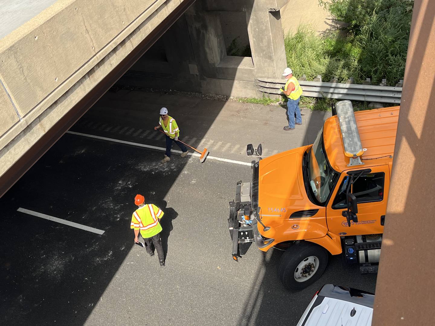 Illinois Department of Transportation crews clean up debris that fell off the bridge over Interstate 55 in Joliet on Monday, Aug. 19, 2024. All lanes of Black Road were closed between Northeast Frontage Road and Bronk Road.