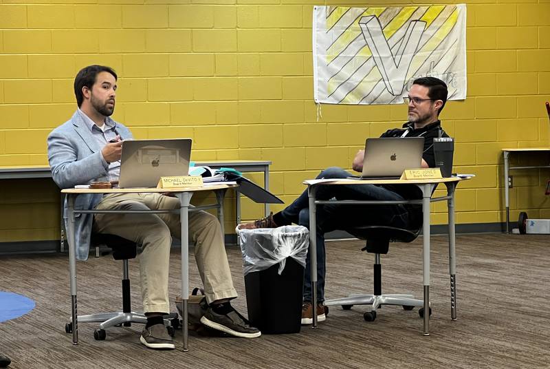 Sycamore board of education Vice President Michael DeVito talks with board member Eric Jones at a July 30, 2024 board of education meeting inside Sycamore Middle School.