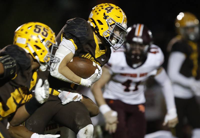 Jacobs' Joey Scrivani looks for running room during a IHSA Class 7A first round playoff football game Friday, Oct. 28, 2022, between Jacobs and Brother Rice at Jacobs High School in Algonquin.