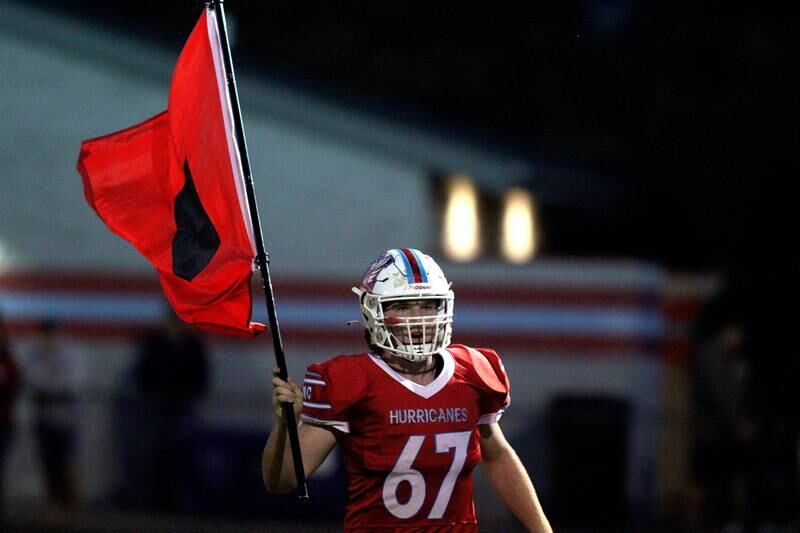 Marian Central’s Hurricanes take the field to face Chicago Hope in varsity football at Woodstock Friday night.