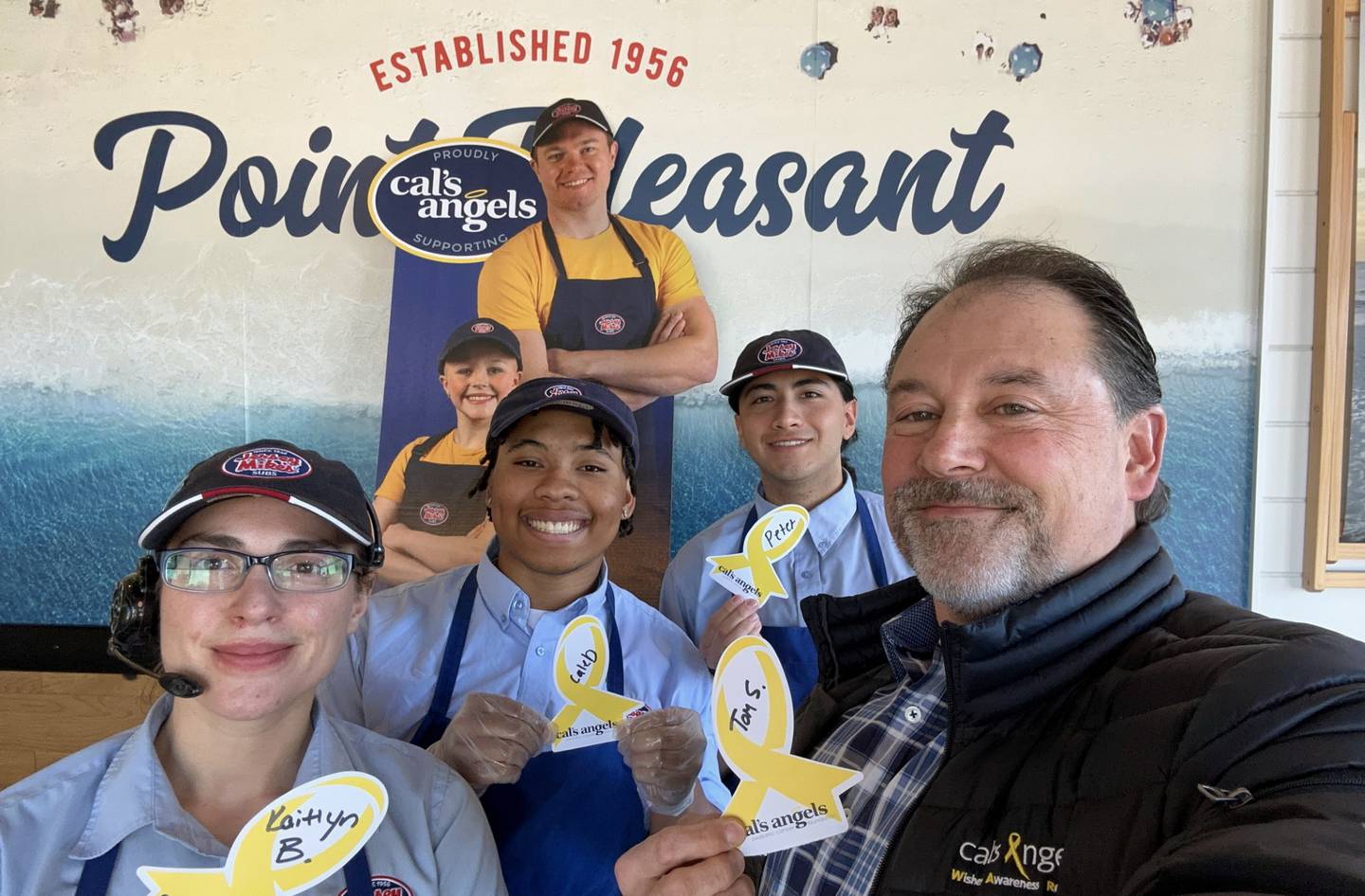 Tom Sutter (right) with Jersey Mike's Subs staff members at the sub shop located at 469 Redington Dr. in South Elgin.