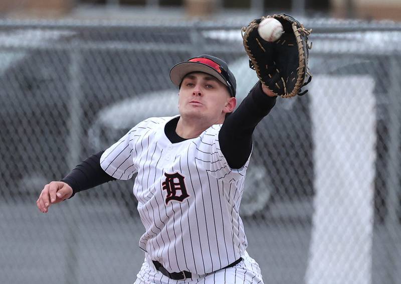 DeKalb's Paul Kakoliris stretches for the throw at first to force out a Harlem baserunner during their game Tuesday, April 1, 2025, at DeKalb High School.