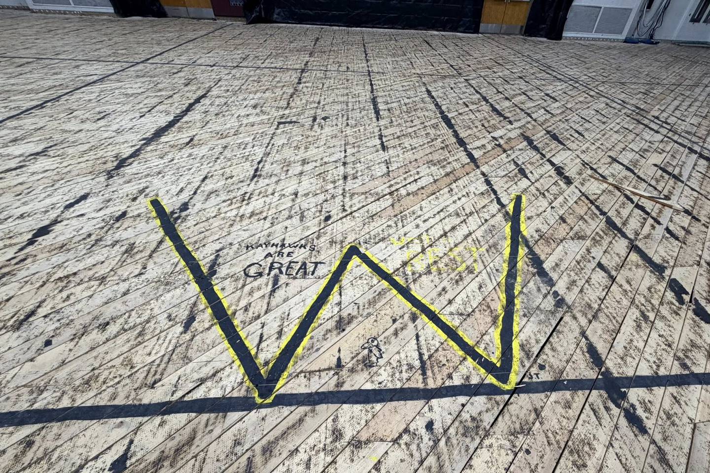 The Kankakee High School gym floor was removed following damage from the March 10 storms, showing the base layer of flooring in a post on April 1, 2026. Some areas of the subfloor have messages from the past.