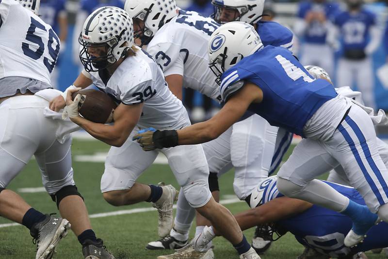 Cary-Grove's Holden Boone runs out of the tackle attempt of Geneva's Troy Velez during an IHSA Class 6A semifinal football game on Saturday, Nov. 23, 2024, at Geneva High School.