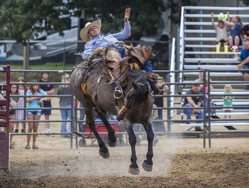 Next Level Pro Bronc cowboy Wyatt Wegener hangs on to “Roll the Dice” Wednesday, August 14, 2024, at the Whiteside County Fair in Morrison.