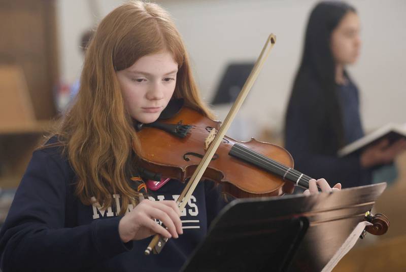Layla Vogl, a student at Academy of St. Carlo Acutis, plays her viloin in the choir loft during the first ever all-school Mass on Friday, Jan. 30, 2026 at St. Joseph’s Catholic Church in Peru.