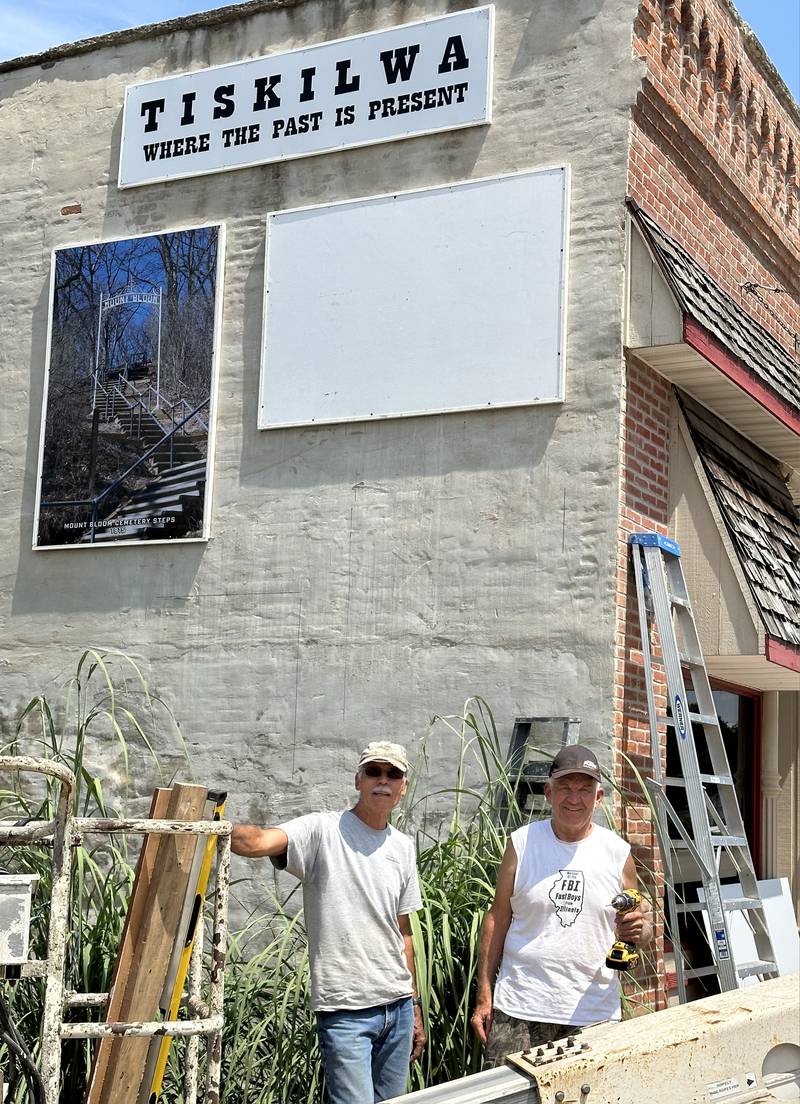 At noon on Saturday, August 5, Pow Wow participants are invited to a brief dedication program for the Historical Images Mural at 127 Main Street in Tiskilwa. A crew of society board members, including Bill Wendle and Randy Senneff (pictured), have installed the panels of the mural.