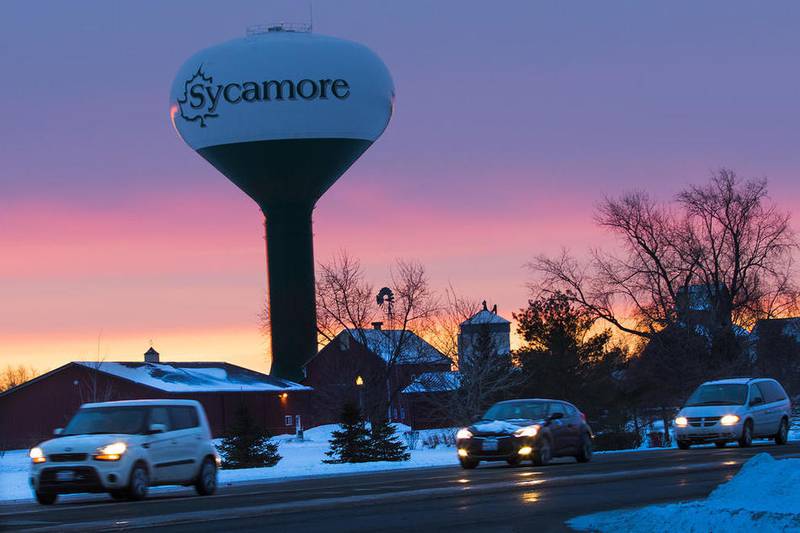 Morning commuters travel along N. Main Street in Sycamore as the winter sunrise paints the sky in warm pastels by the water tower on Tuesday, Dec. 20, 2016.