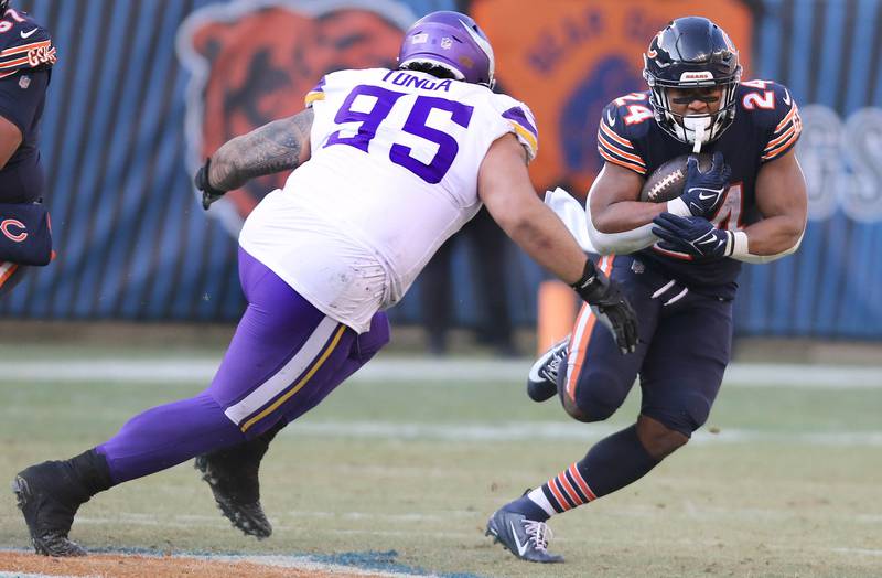 Chicago Bears running back Khalil Herbert tries to get by Minnesota Vikings defensive tackle Khyiris Tonga Sunday, Jan. 8, 2023, during their game at Soldier Field in Chicago.