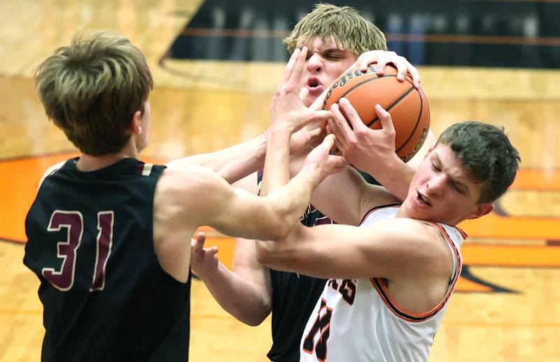 DeKalb's Eric Rosenow  fights for the ball among two Dunlap players during their game Monday, Nov. 21, 2022, at DeKalb High School.