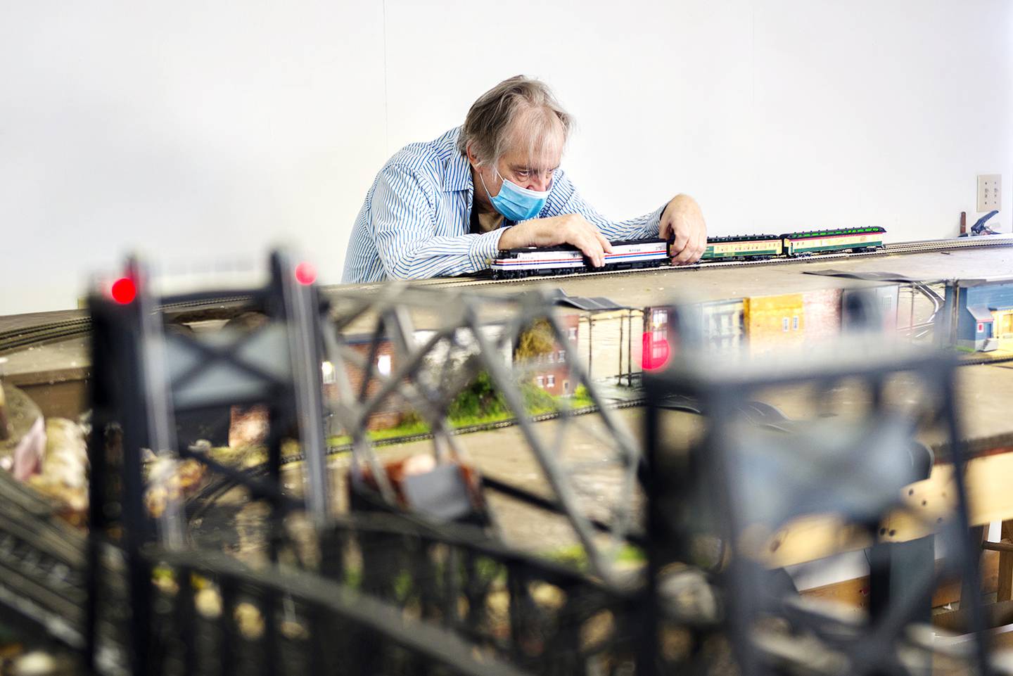 John Urbaniak of Sterling sets the train on the track at the Northwest Illinois Model Railroad Club in Chadwick.  "Things can run great for 10-12 times then just like that it jumps the track."
