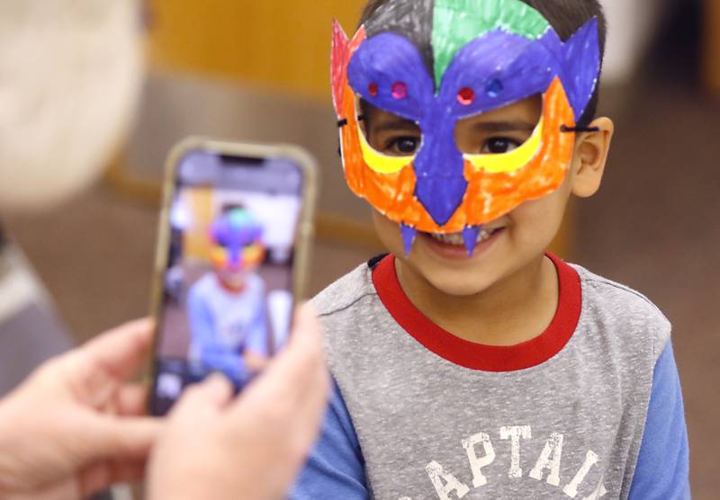 Craig Lunak, 5, poses for a photo with his vampire mask as children make masks on Wednesday, Oct. 23, 2024, during at Kids Crafternoon at the Harvard Diggins Library. Children were able to chose between several Halloween themed masks to make.