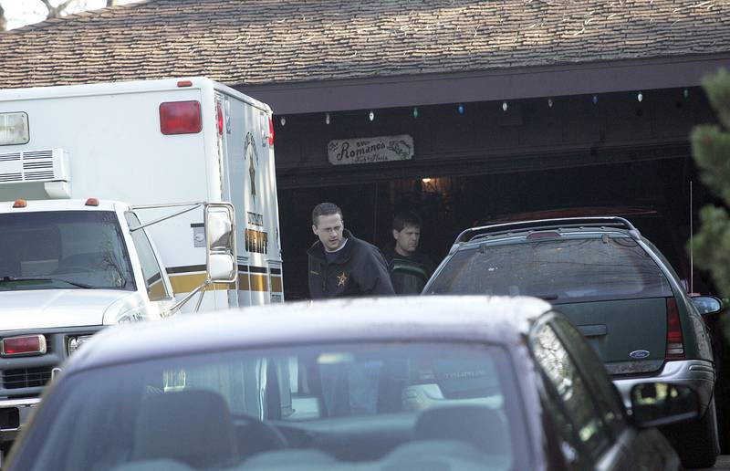 Police investigaters are seen at the home of Gloria and Nick Romano on the 6200 block of Kilkenny Drive near Crystal Lake. The couple was found murdered in November 2006.