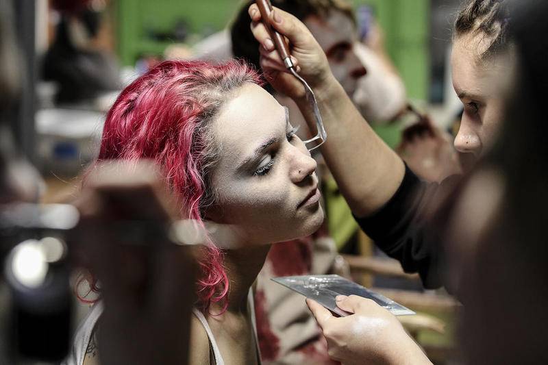 Makeup artists apply prosthetics and makeup Thursday before the opening night of Statesville Haunted Prison in Crest Hill.