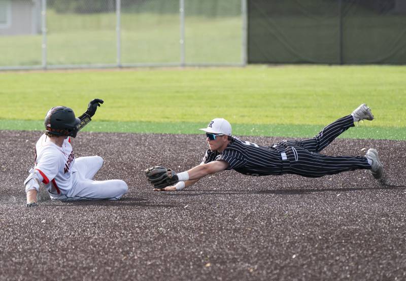 McHenry's Nathan Neidhardt slides into second base safe as Prairie Ridge's Brennan Coyle dives to attempt a tag during their game on Friday, May 16, 2025 at McHenry High School. Ryan Rayburn for Shaw Local