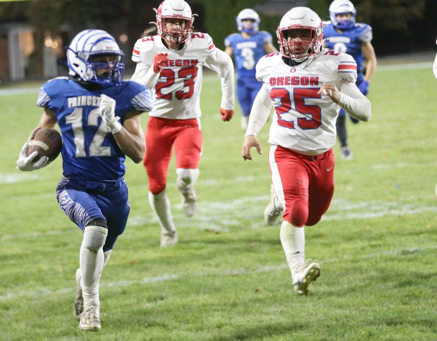 Princeton's Kaydin Gibson sprints down the sidelines on a run past Oregon's Peter Alfano during the Class 3A playoff game on Friday, Nov. 1, 2024 at Princeton High School.