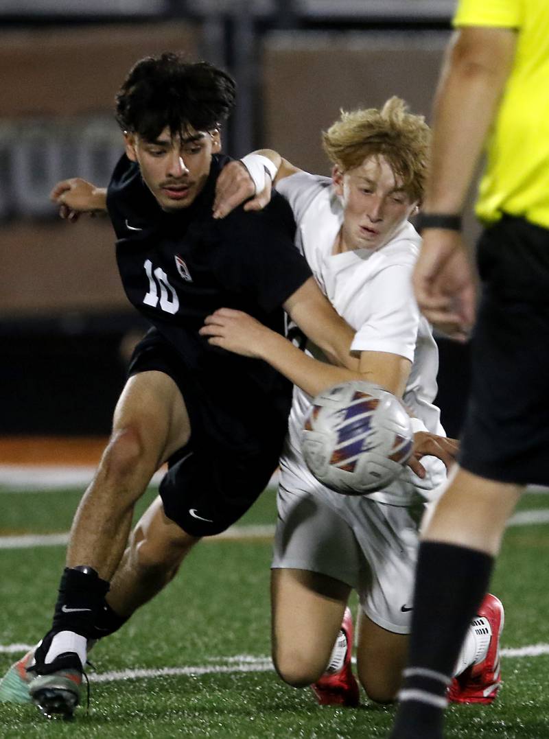McHenry's Aldair Anglada battles with Prairie Ridge's Graham Schroeder for control of the ball during a Fox Valley Conference boys soccer match on Tuesday, Sept. 30, 2025, at McCracken Field in McHenry.