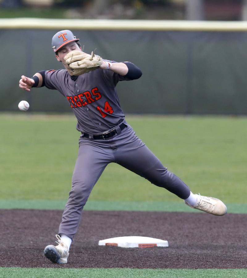 Crystal Lake Central's Ethan Wolf loses the handle of ball as he tries to throw out McHenry’s Carver Cohn during a Fox Valley Conference baseball game on Friday, May 2, 2025, at McHenry High School.