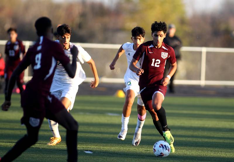Elgin’st Geo Catalan (12) dribbles the ball in the first half of the 3A Boys Soccer Supersectional against York at Streamwood High School on Tuesday, Nov. 1, 2022.