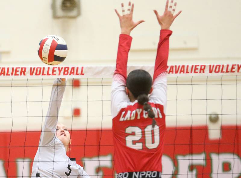 Kaneland's Abigail Carter sends a spike past L-P's Anna Riva on Tuesday, Oct. 7, 2025 in Sellett Gymnasium at L-P High School.