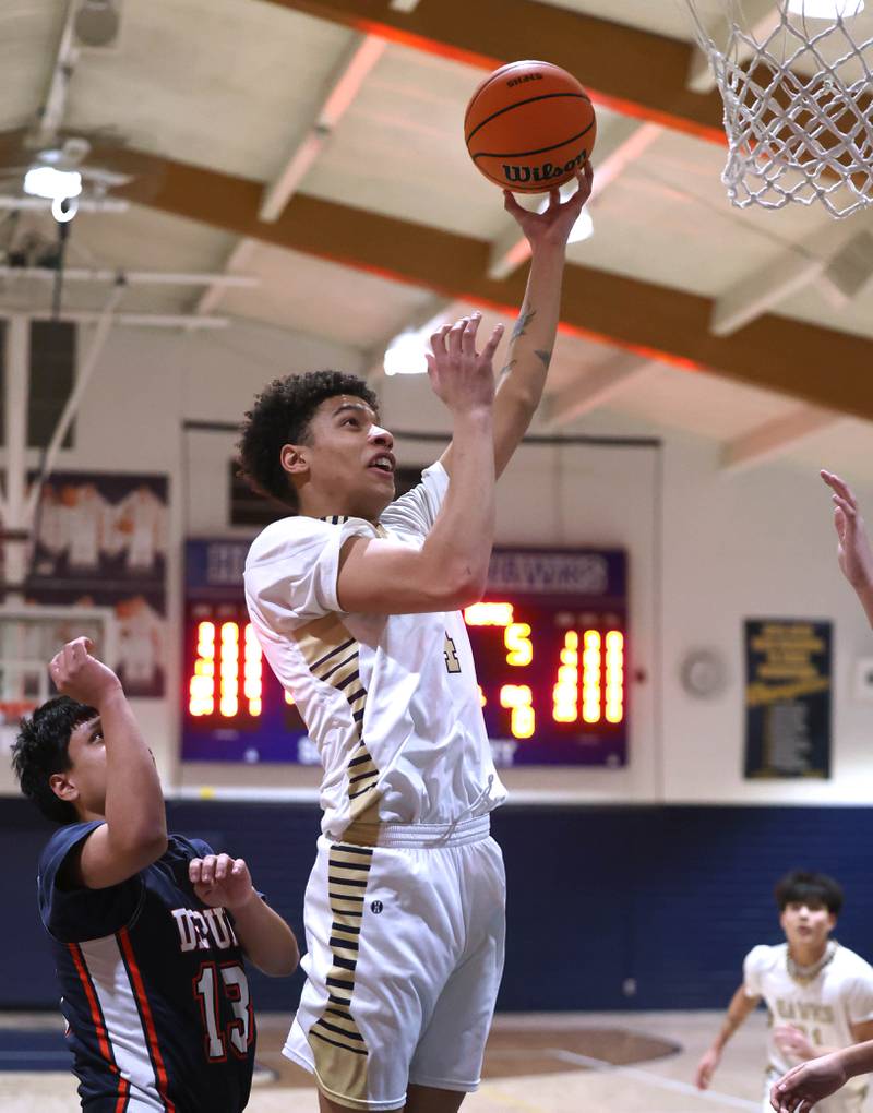 Hiawatha’s Elijah Beaver shoots in front of DePue’s Enrique Lopez during their game Tuesday, Jan. 20, 2026, at Hiawatha High School in Kirkland.