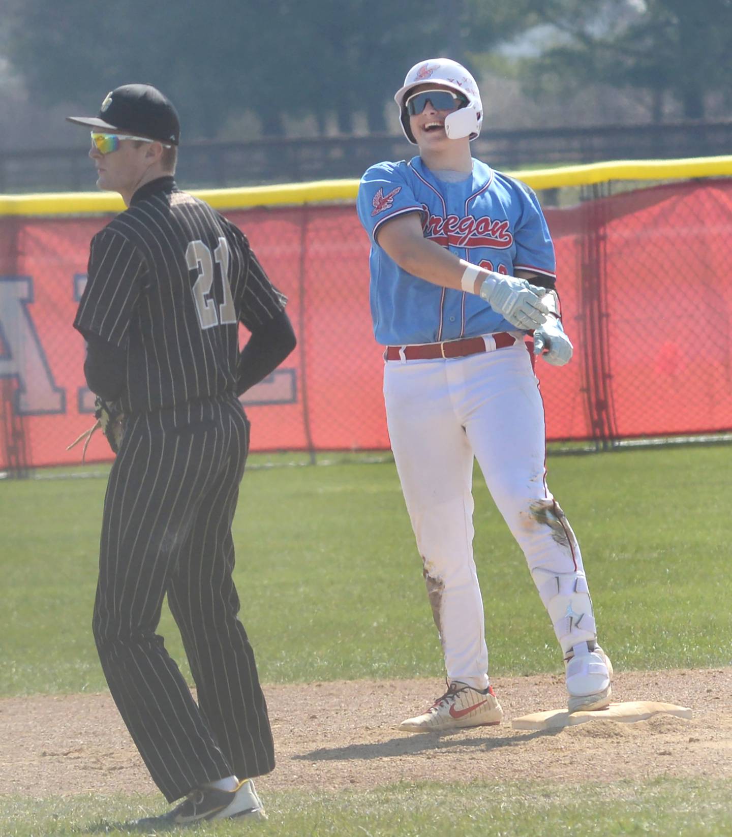 Oregon's Kade Girton looks to the Hawks dugout after hitting a double in a game with Rockford Christian at Oregon High School on Saturday, April 12, 2025.
