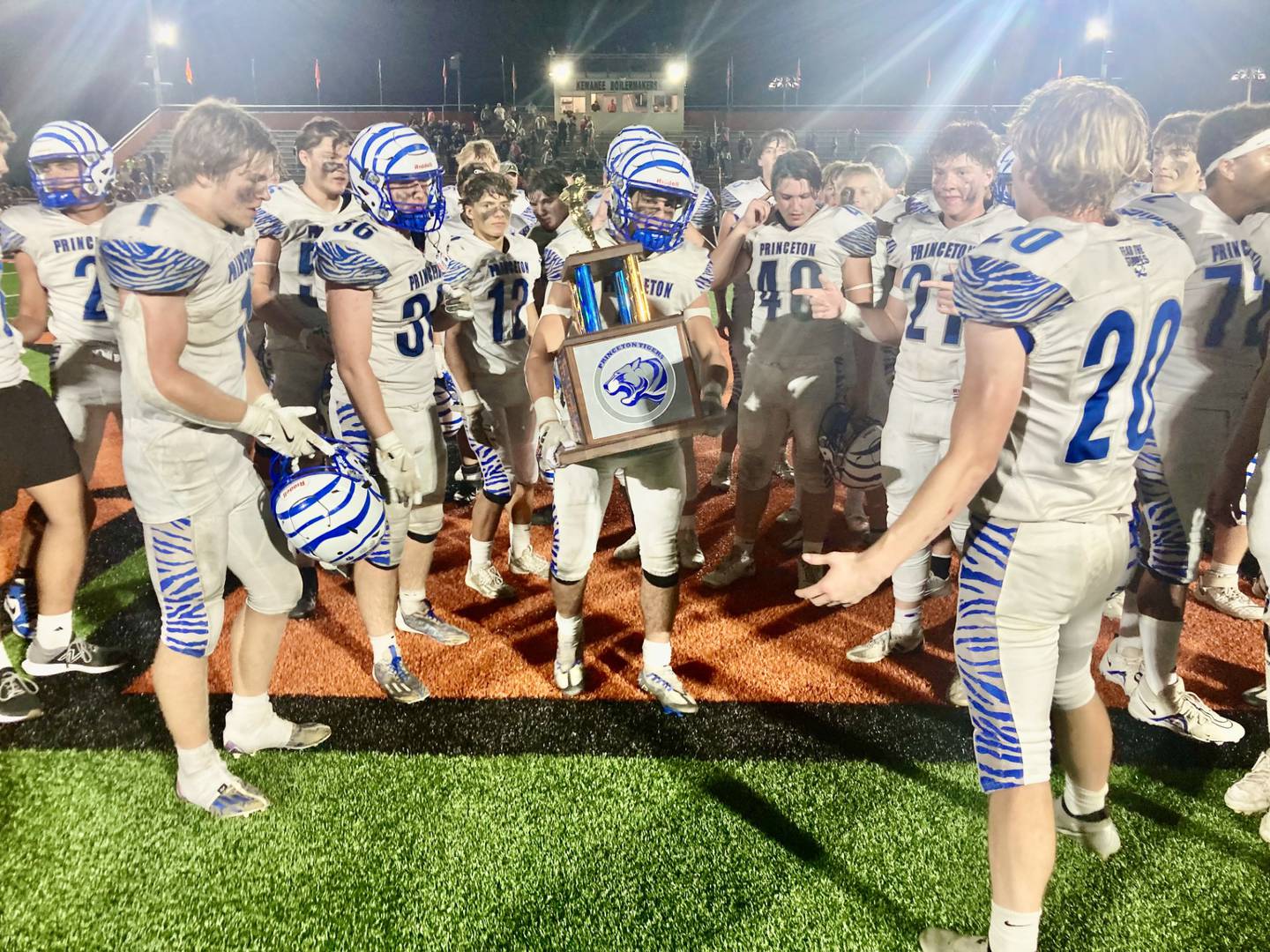 Princeton senior captain Ace Christiansen carries the traveling trophy after the Tigers defeated longtime rival Kewanee 44-15 Friday night The Tigers now lead the all-time series 65-57-4.