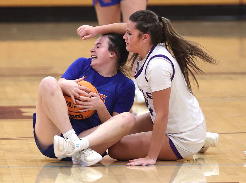 Genoa-Kingston's Zoe Boylen (left) and Rochelle's Audrina Rodriguez go after a loose ball during their game Monday, Dec. 15, 2025, at Rochelle High School.