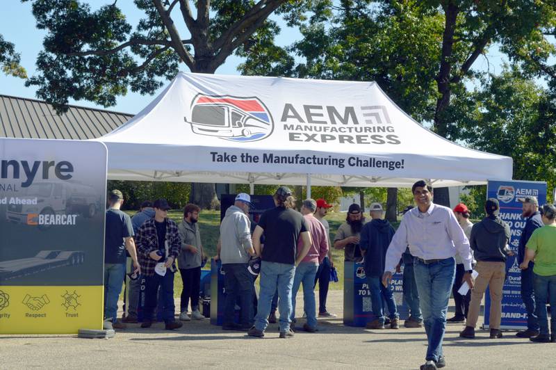 E.D. Etnyre & Co. President and CEO Ganesh Iyer (right) walks past his employees taking part in the Association of Equipment Manufacturers' Manufacturing Express challenge on Tuesday, Oct. 8, 2024, for a chance to win a Ford F-150. E.D. Etnyre & Co. is located in Oregon and was one of 80 stops across 20 states for AEM's Manufacturing Express tour.