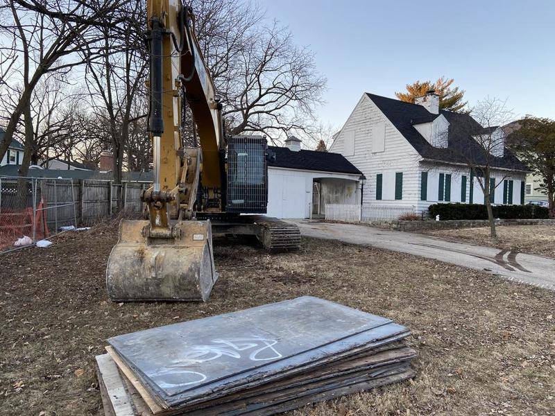 Construction equipment sits outside the home formerly occupied by Joann Cunningham and Andrew Freund Sr. on Tuesday in Crystal Lake.  The house where their son, AJ Freund, was allegedly killed is scheduled to be demolished Wednesday.