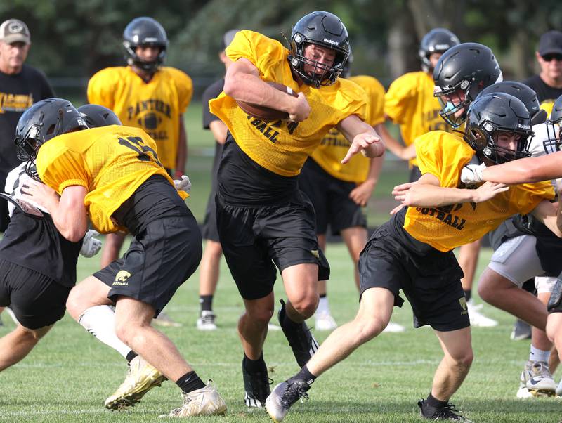 Lena-Winslow’s Aiden Wild carries the ball as they scrimmage Sycamore Thursday, July 24, 2025, during a joint practice with Byron, Lena-Winslow and Sycamore at Sycamore High School.