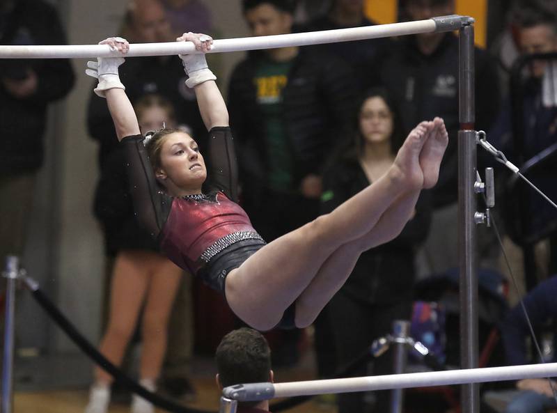 Prairie Ridge’s Gabby Riley competes in the of the uneven parallel bars Friday, Feb. 17, 2023, during the IHSA Girls State Final Gymnastics Meet at Palatine High School.