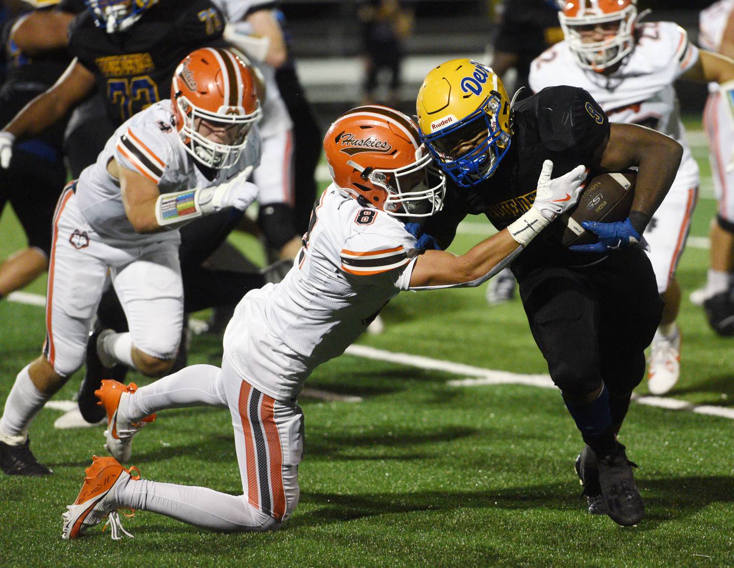 Warren's Aaron Stewart, right, breaks a tackle attempt by Hersey’s Luke Casey and continues to the end zone for a touchdown during the opening night of high school football on Friday, Aug. 30, 2024 in Gurnee.