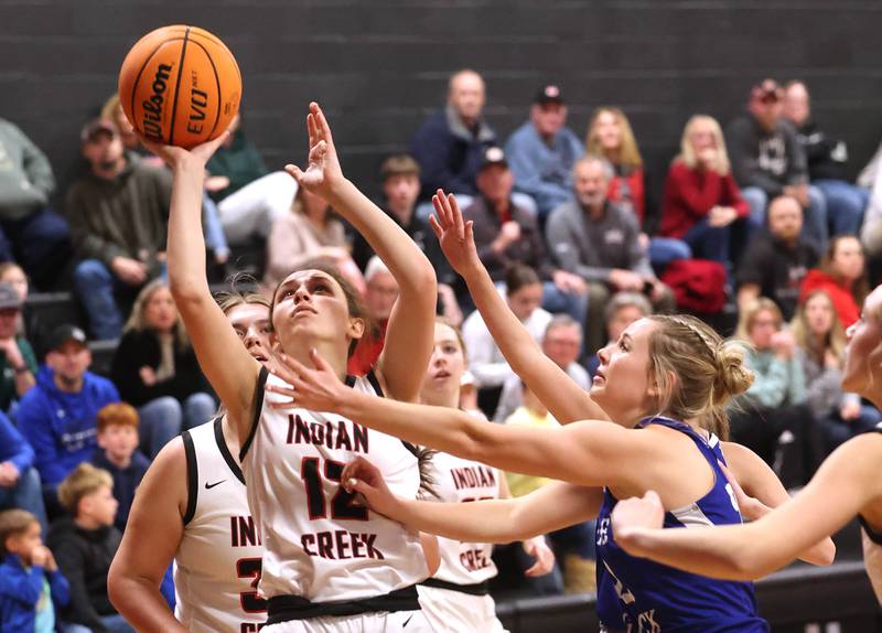 Indian Creek's Isabella Turner shoots a layup in front of Hinckley-Big Rock's Anna Hermann during their game Monday, Jan. 13, 2025, at Indian Creek High School in Shabbona.