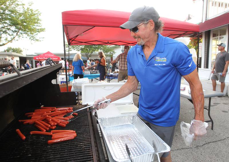 Jeff Sode, Village of Wauconda mayor, makes hot dogs on the grill for everyone during National Night Out on Main Street on Tuesday, August 1st in Wauconda.  
Photo by Candace H. Johnson for Shaw Local News Network.