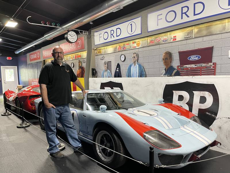 Volo Museum Director Brian Grams stands near a couple of the Hollywood-used cars in the museum's new "Ford v Ferrari" exhibit, opening the Fourth of July weekend