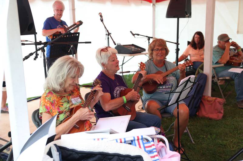 A group of ladies gather to jam together at one of the tents at the Gebhard Woods Dulcimer & Traditional Music Festival on Saturday June 8, 2024 in Morris.