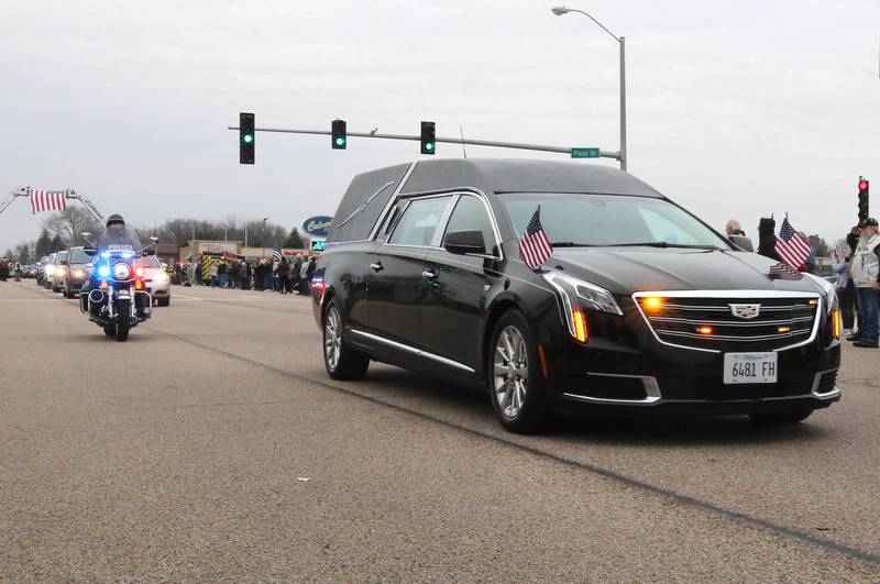 The hearse carrying the body of DeKalb County Sheriff’s Deputy Christina Musil drives down DeKalb Avenue in Sycamore Monday, April 1, 2024, on its way to Butala Funeral Home during a processional to honor the fallen officer. Musil, 35, was killed Thursday while on duty after a truck rear-ended her police vehicle in Waterman.