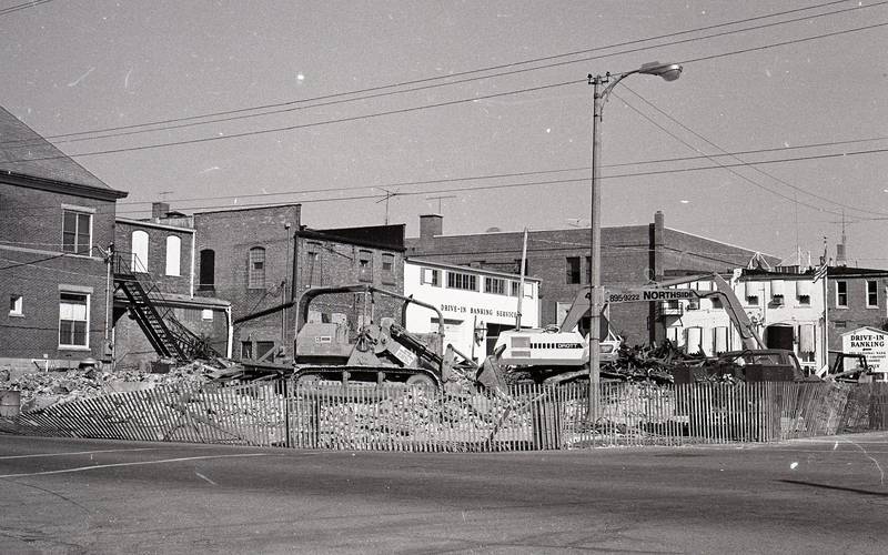 Demolishing buildings looking northwest on the corner of Elm and Maple in Sycamore, October 1980.
