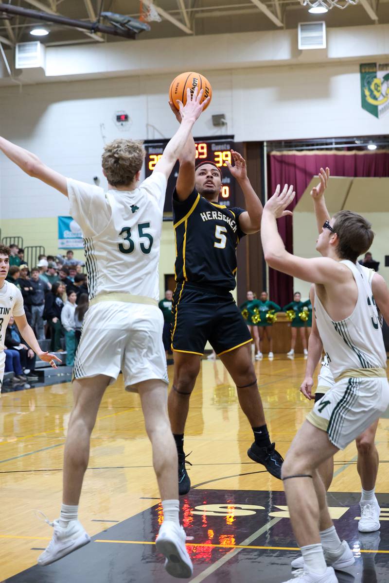 Herscher's Alek Draper shoots under pressure from Bishop McNamara's Richie Darr, left, during Bishop McNamara's 71-42 victory in the IHSA Class 2A Herscher Regional semifinal on Wednesday, Feb. 25, 2026.