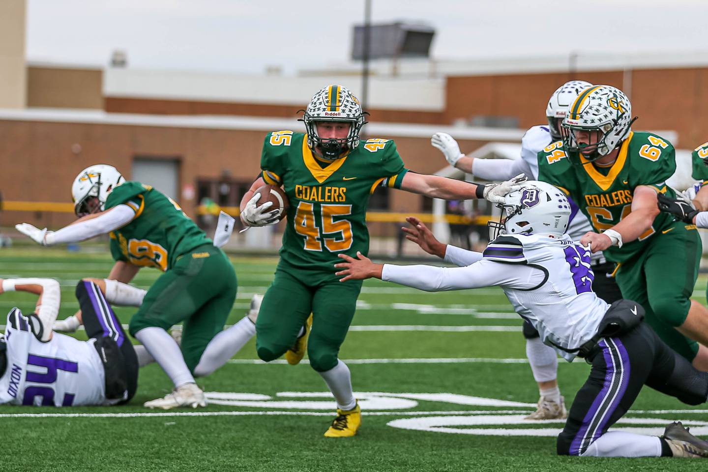 Coal City's Landin Benson (45) stiff-arms Dixon's Devon Wallace (88) during a Class 4A quarterfinal football game on Saturday, Nov. 16, 2024, in Coal City.